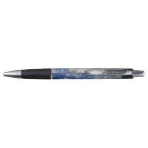 Whimsical fluffy white clouds in Cornish blue sky Pen