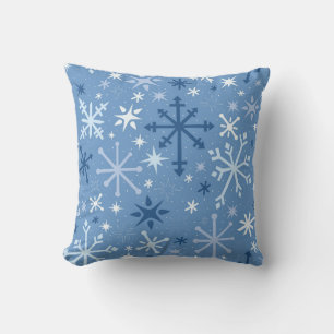 Whimsical flurry of blue snowflakes on sky blue throw pillow