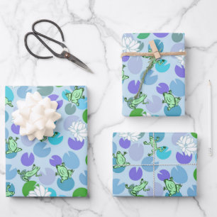 Whimsical green frogs and lily pads on light blue wrapping paper sheet