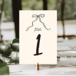 Whimsical Quirky Handwritten Bow Table Number<br><div class="desc">Whimsical bridal shower table number featuring a beautiful hand-drawn bow in a fun and playful style,  accompanied by a casual,  handwritten font that perfectly captures the excitement and joy of the occasion.
The welcome sign comes in a neutral colour scheme of forest dark grey on ecru.</div>