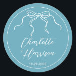 Whimsical Script Ribbon Border Wedding  Classic Round Sticker<br><div class="desc">A simple handwritten script modern minimalist white typography wedding wine labels on blue,  framed with a wavy ribbon frame with bow in a hand drawn style. Informal whimsical coquette style. Available in 2 sizes and finishes are matte or glossy.</div>