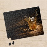 Whiskey on the Rocks Jigsaw Puzzle<br><div class="desc">Jigsaw puzzle of an ice cube splashing into a crystal whiskey glass on a rustic wood table. Choose from the different sizes available.</div>