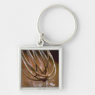 Whisking the chocolate in a saucepan to melt the keychain