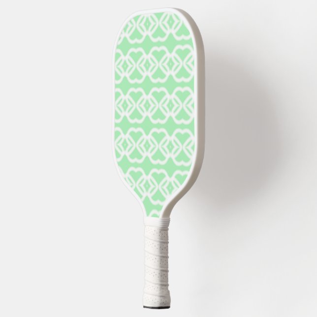 White abstract shapes on green pickleball paddle (Left)