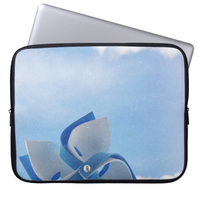 White and blue handheld windmill under cloudy skie laptop sleeve (Front)