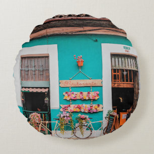 WHITE BICYCLE PARKED BESIDE TEAL PAINTED CONCRETE  ROUND PILLOW