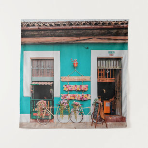 WHITE BICYCLE PARKED BESIDE TEAL PAINTED CONCRETE  TAPESTRY