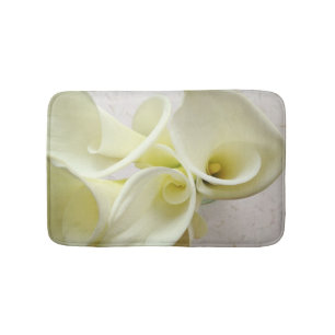 White calla lilies from above bath mat