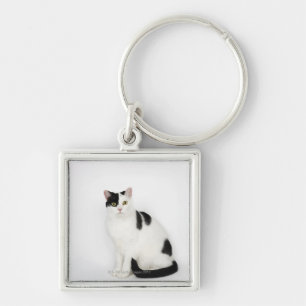 White cat with black spots keychain