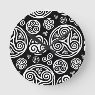 White celtic triskels on black round clock