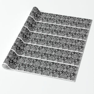 White celtic triskels on black wrapping paper