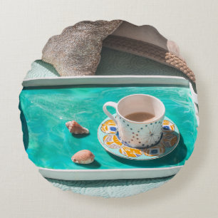 White ceramic mug on white serving tray round pillow