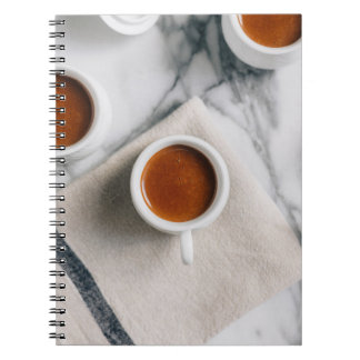 WHITE CERAMIC TEACUP FILLED WITH RED LIQUID NOTEBOOK