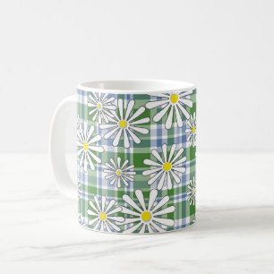 White chamomile flowers on a green blue chequered  coffee mug