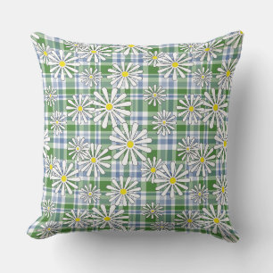 White chamomile flowers on a green blue chequered throw pillow