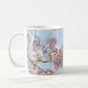 White cherry blossom under clear blue sky in the m coffee mug