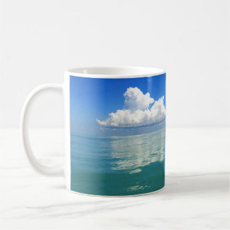 White cloud over a placid ocean coffee mug