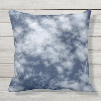 White clouds against blue sky on throw pillow