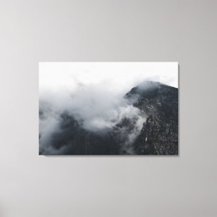 White clouds over the dark rocky mountains canvas print