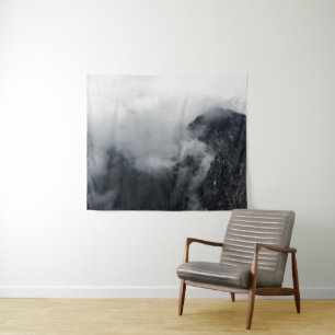 White clouds over the dark rocky mountains tapestry