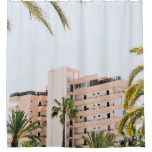 WHITE CONCRETE BUILDING BESIDE GREEN PALM TREE UND