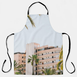 WHITE CONCRETE BUILDING BESIDE GREEN PALM TREE UND APRON