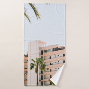 WHITE CONCRETE BUILDING BESIDE GREEN PALM TREE UND BATH TOWEL
