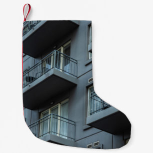 WHITE CONCRETE BUILDING WITH WHITE METAL RAILINGS SMALL CHRISTMAS STOCKING