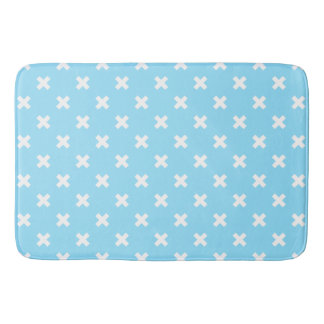 White cross stitches on baby blue bath mat