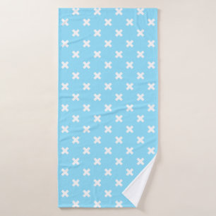 White cross stitches on baby blue bath towel