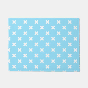 White cross stitches on baby blue doormat