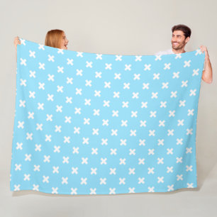 White cross stitches on baby blue fleece blanket