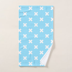 White cross stitches on baby blue hand towel
