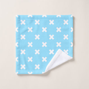 White cross stitches on baby blue wash cloth