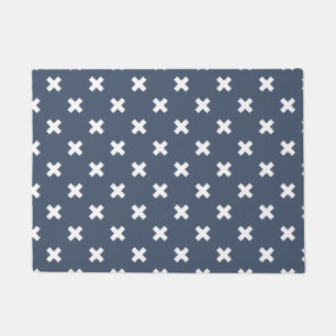 White cross stitches on blue-gray doormat