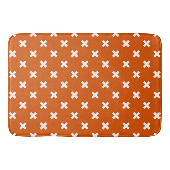 White cross stitches on burnt orange bath mat (Front)