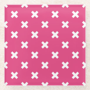 White cross stitches on fuchsia glass coaster
