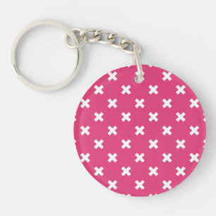 White cross stitches on fuchsia keychain