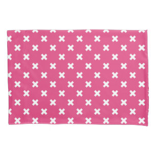 White cross stitches on fuchsia pillowcase