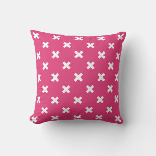 White cross stitches on fuchsia throw pillow