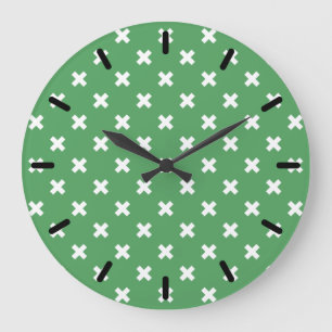 White cross stitches on green large clock