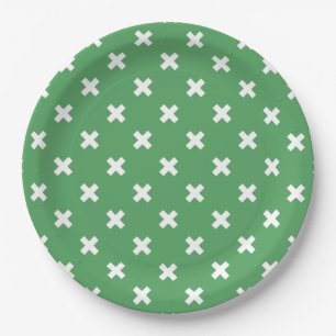 White cross stitches on green paper plate