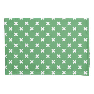 White cross stitches on green pillowcase