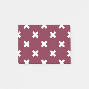 White cross stitches on mulberry post-it notes