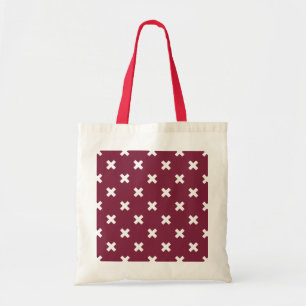 White cross stitches on mulberry tote bag