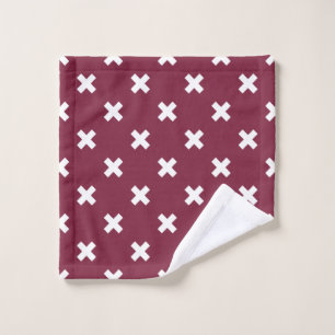 White cross stitches on mulberry wash cloth