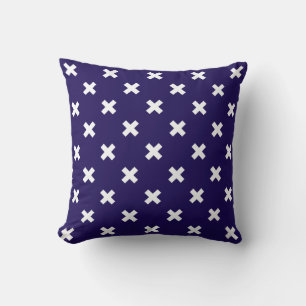 White cross stitches on navy blue throw pillow