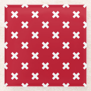 White cross stitches on red glass coaster