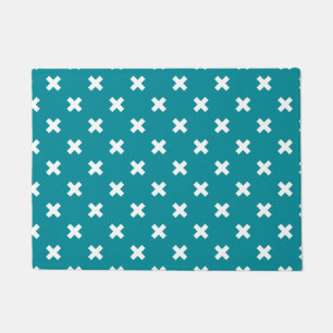 White cross stitches on teal doormat