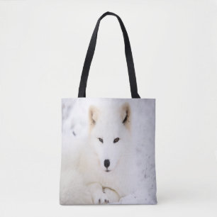 White cute fox in snow looking at you tote bag